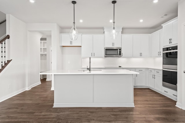 kitchen featuring decorative backsplash, dark wood-style flooring, recessed lighting, a sink, and appliances with stainless steel finishes