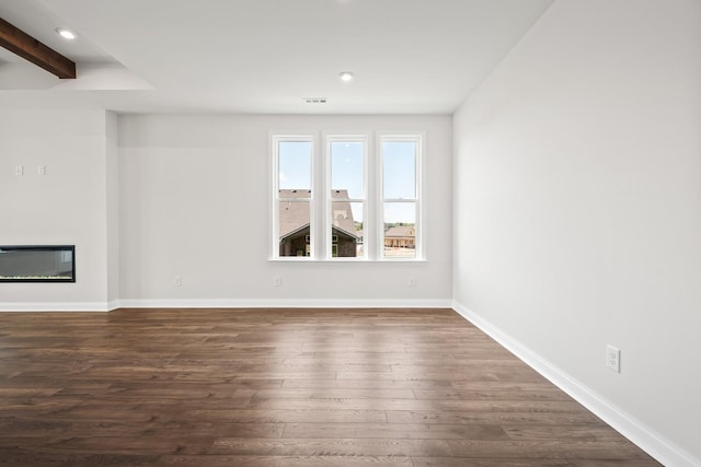 unfurnished living room featuring dark wood finished floors, a glass covered fireplace, recessed lighting, baseboards, and visible vents