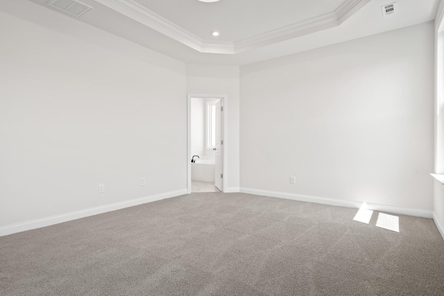 unfurnished room featuring visible vents, baseboards, crown molding, and carpet floors