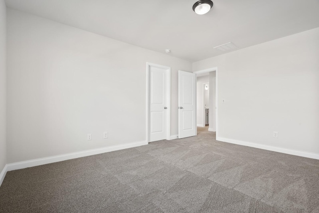 empty room with baseboards and carpet floors