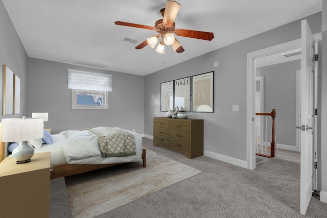 bedroom with carpet flooring, ceiling fan, visible vents, and baseboards