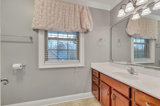 bathroom featuring crown molding, baseboards, vanity, and a healthy amount of sunlight
