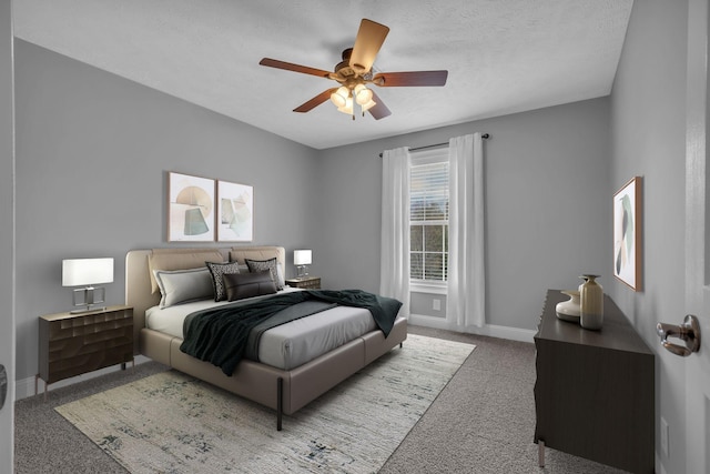 carpeted bedroom featuring a textured ceiling, baseboards, and ceiling fan