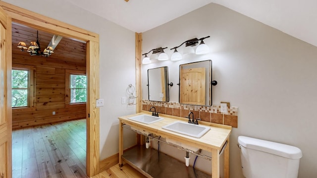 bathroom featuring a sink, decorative backsplash, toilet, and hardwood / wood-style floors