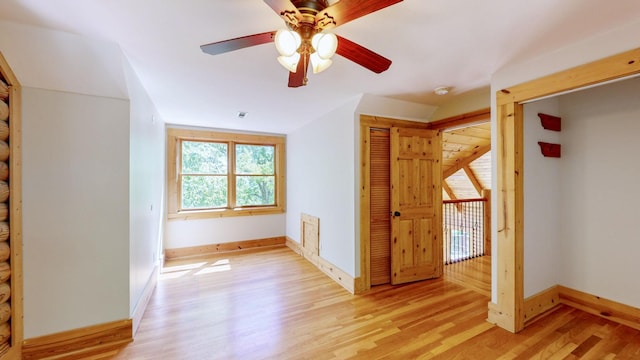 bonus room with baseboards, a ceiling fan, and light wood-type flooring