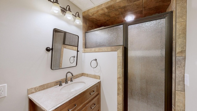 bathroom with a shower stall and vanity