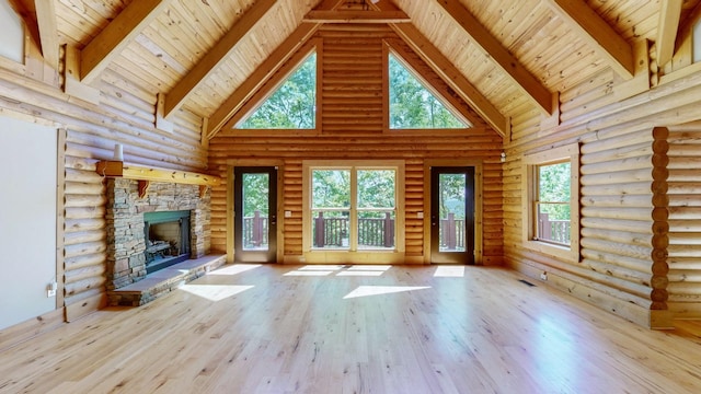 unfurnished living room featuring wood-type flooring, rustic walls, a fireplace, beamed ceiling, and high vaulted ceiling