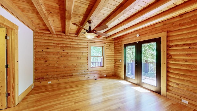 spare room with rustic walls, french doors, light wood-style flooring, wooden ceiling, and beamed ceiling