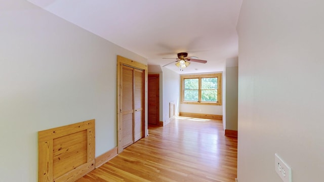 hall with baseboards and light wood-type flooring