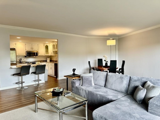 living room featuring crown molding, baseboards, and dark wood-style floors