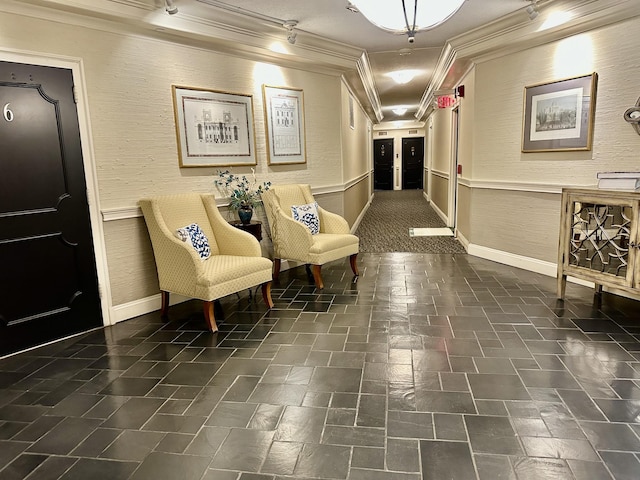 corridor featuring track lighting and ornamental molding