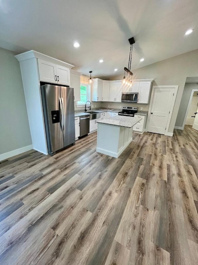 kitchen featuring a sink, appliances with stainless steel finishes, dark wood finished floors, and white cabinetry
