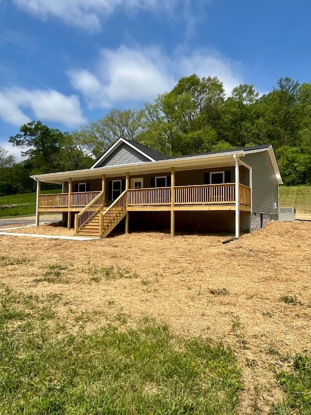 view of front of property with a porch and stairway