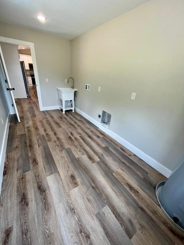 laundry room featuring laundry area, wood finished floors, baseboards, electric dryer hookup, and washer hookup