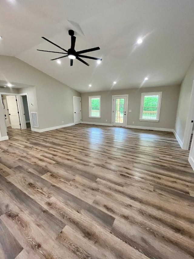 unfurnished living room featuring a ceiling fan, baseboards, and wood finished floors