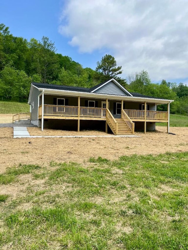 view of front of house with stairs, covered porch, and crawl space