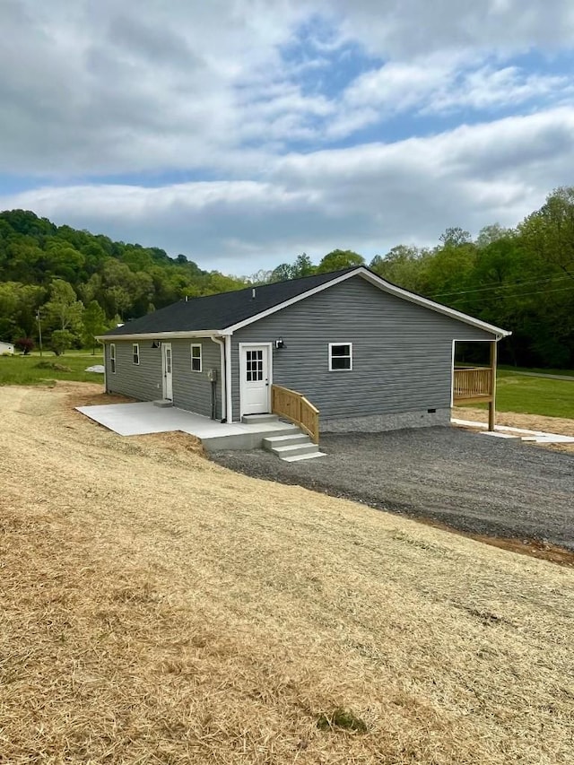 back of property with a lawn and a patio area