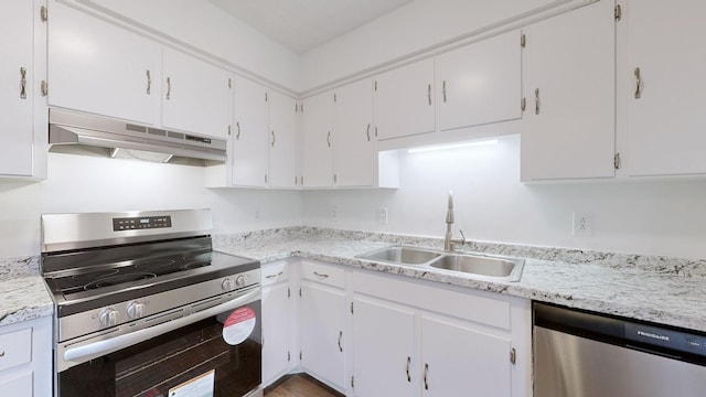 kitchen with under cabinet range hood, white cabinetry, appliances with stainless steel finishes, and a sink