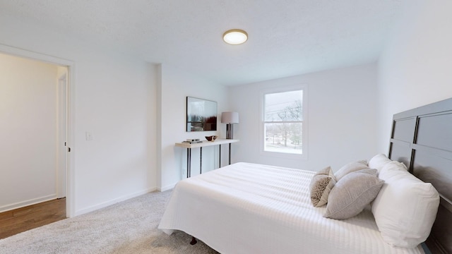 carpeted bedroom featuring baseboards
