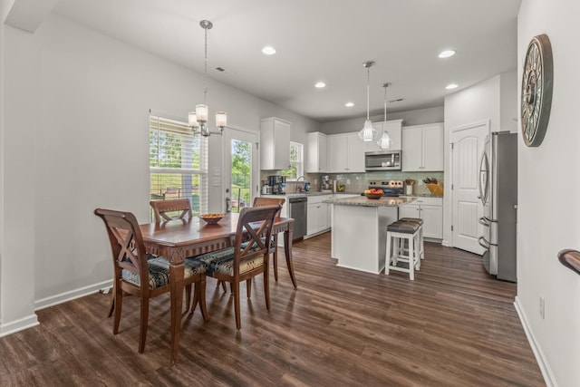 dining room featuring baseboards, dark wood-style flooring, recessed lighting, and a chandelier