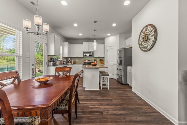 dining room with recessed lighting, baseboards, visible vents, and dark wood-type flooring