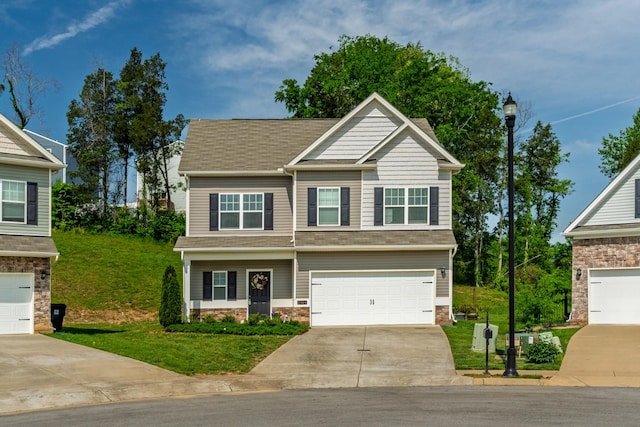 craftsman house with a garage, a shingled roof, a front yard, and concrete driveway