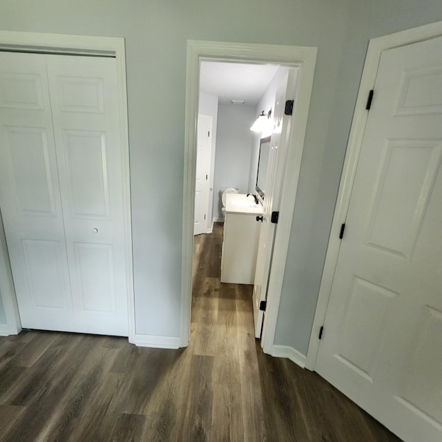 hall with baseboards and dark wood finished floors