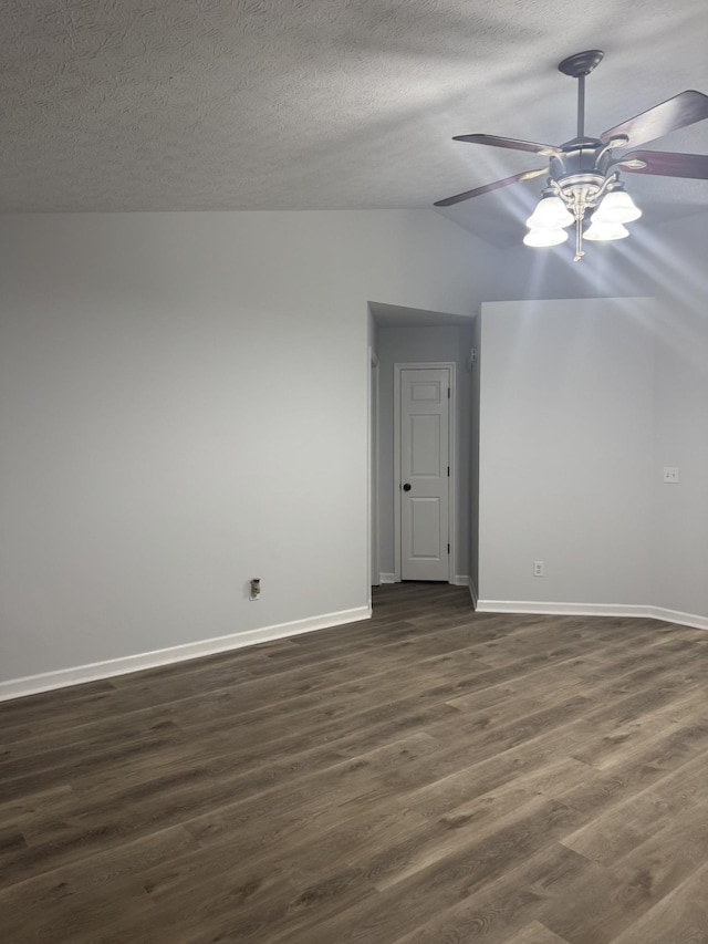 unfurnished room featuring a ceiling fan, a textured ceiling, baseboards, dark wood-style floors, and lofted ceiling