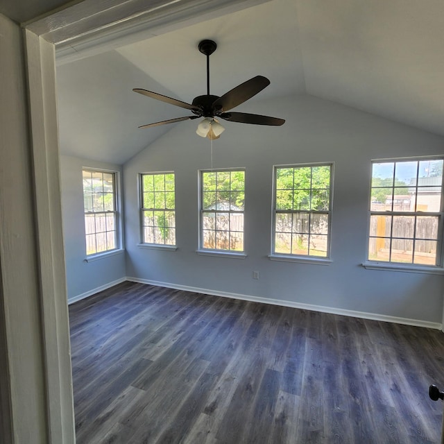empty room with a ceiling fan, baseboards, dark wood-style floors, and lofted ceiling