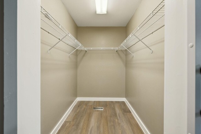 spacious closet with wood finished floors