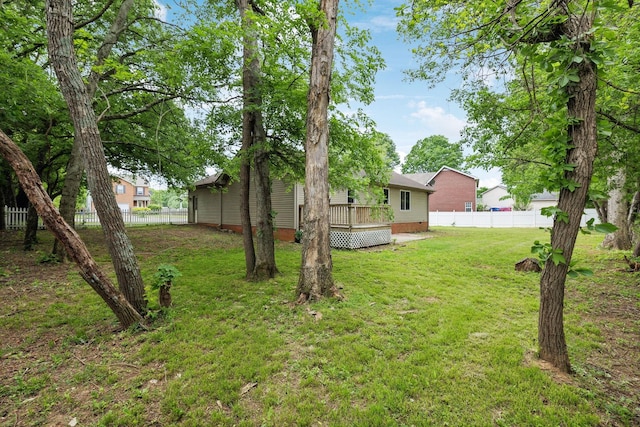 view of yard with fence and a deck