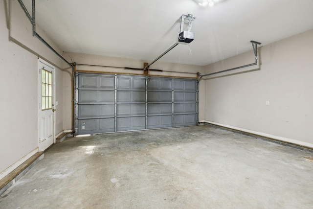 garage with baseboards and a garage door opener