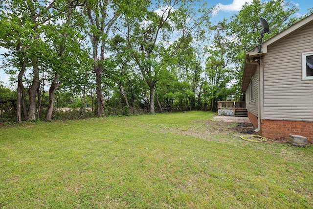 view of yard with a wooden deck