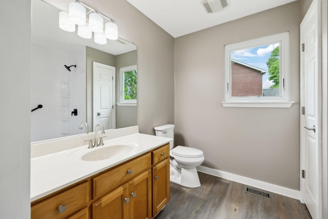 full bath with wood finished floors, toilet, a shower, and visible vents