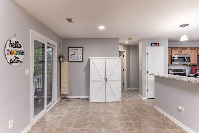 1137 Stillwood Dr, Clarksville, TN 37042 - kitchen featuring appliances with stainless steel finishes, baseboards, recessed lighting, pendant lighting, and brown cabinetry