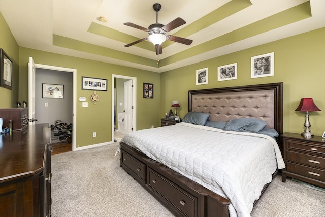 1137 Stillwood Dr, Clarksville, TN 37042 - bedroom featuring a raised ceiling, light carpet, baseboards, ceiling fan, and ensuite bath