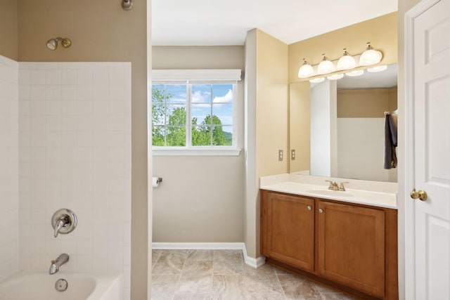 bathroom with baseboards, shower / bathing tub combination, and vanity