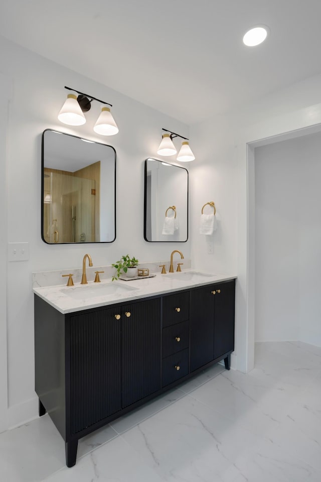 bathroom featuring double vanity, a sink, and marble finish floor