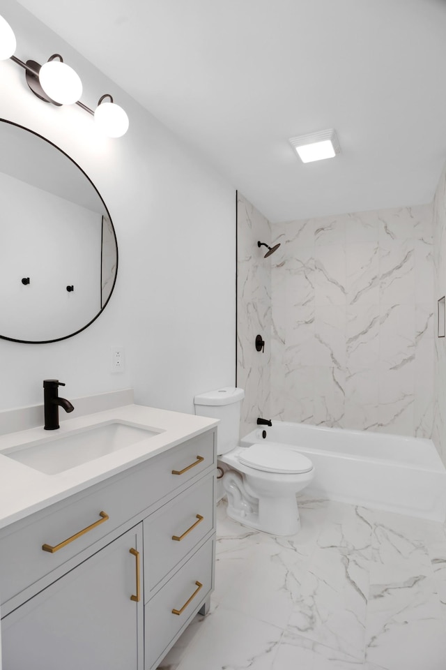 bathroom featuring toilet, bathing tub / shower combination, marble finish floor, and vanity