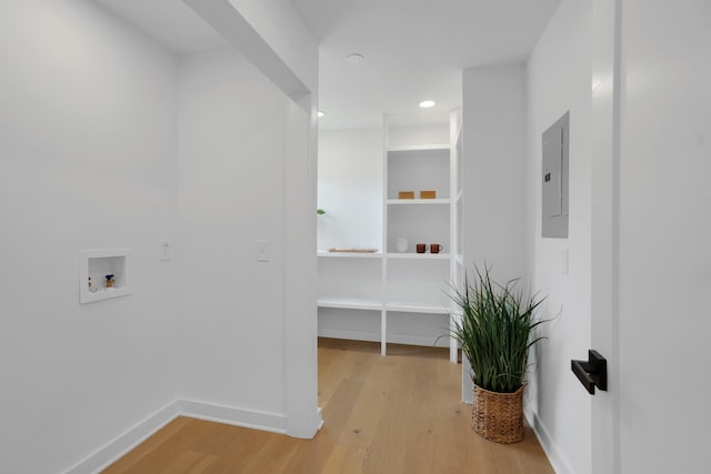 clothes washing area featuring baseboards, recessed lighting, electric panel, washer hookup, and light wood finished floors