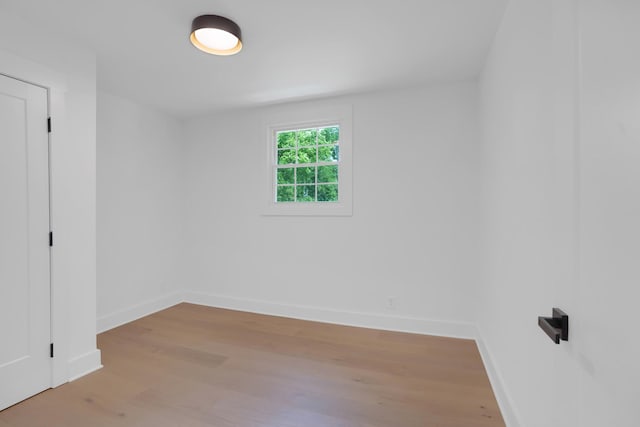 empty room featuring baseboards and wood finished floors