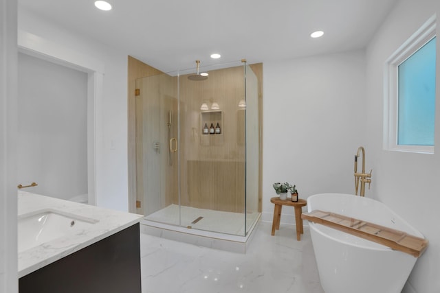 bathroom with recessed lighting, a freestanding tub, marble finish floor, and a stall shower