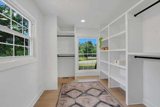 walk in closet featuring visible vents and wood finished floors