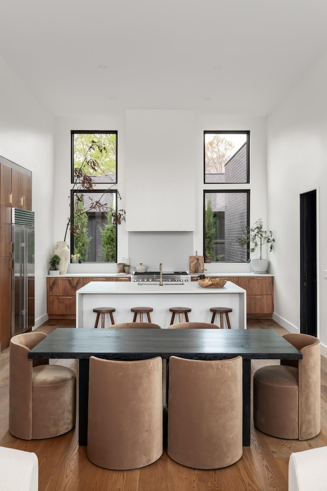 dining space featuring light wood-type flooring and baseboards