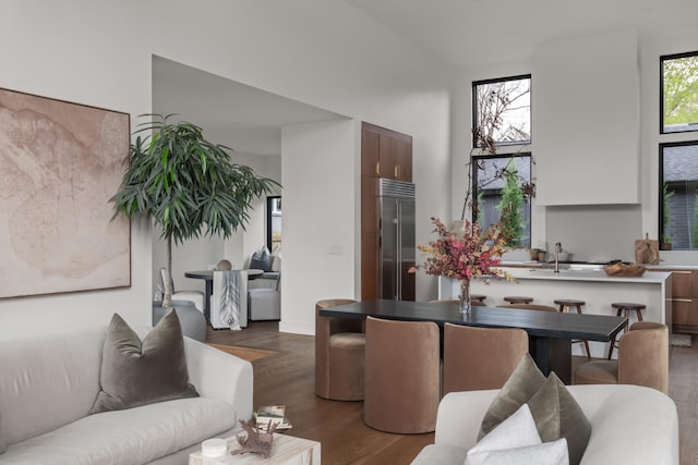 living area featuring wood finished floors and a towering ceiling
