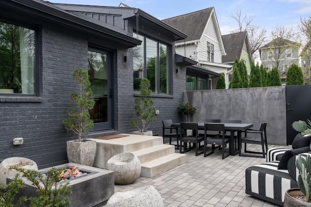 view of patio / terrace featuring fence, outdoor dining area, and an outdoor fire pit