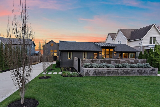 back of property featuring a lawn, fence, and roof with shingles