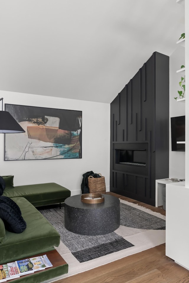 living room with wood finished floors and lofted ceiling