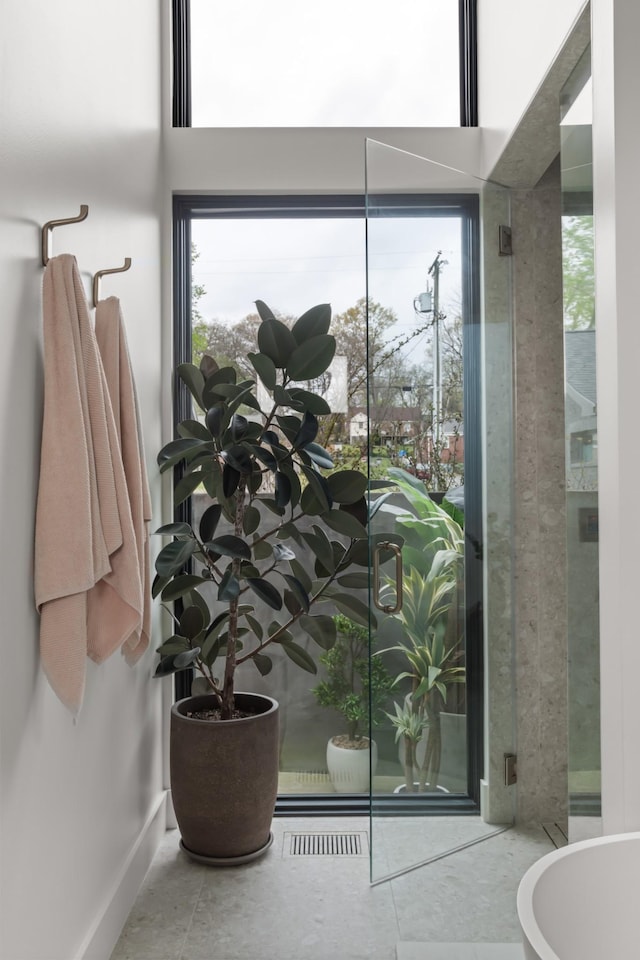 bathroom with baseboards, visible vents, and plenty of natural light