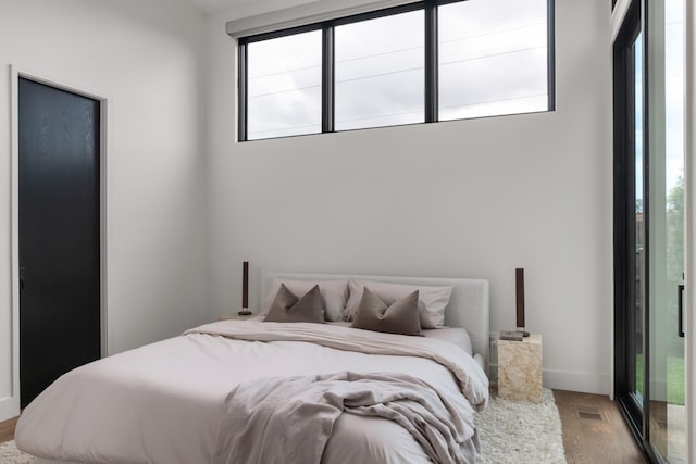 bedroom with visible vents and wood finished floors